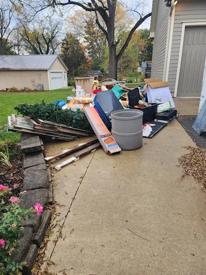 Dumpster being loaded with debris for 3 Yard Dumpster Rental in St. John